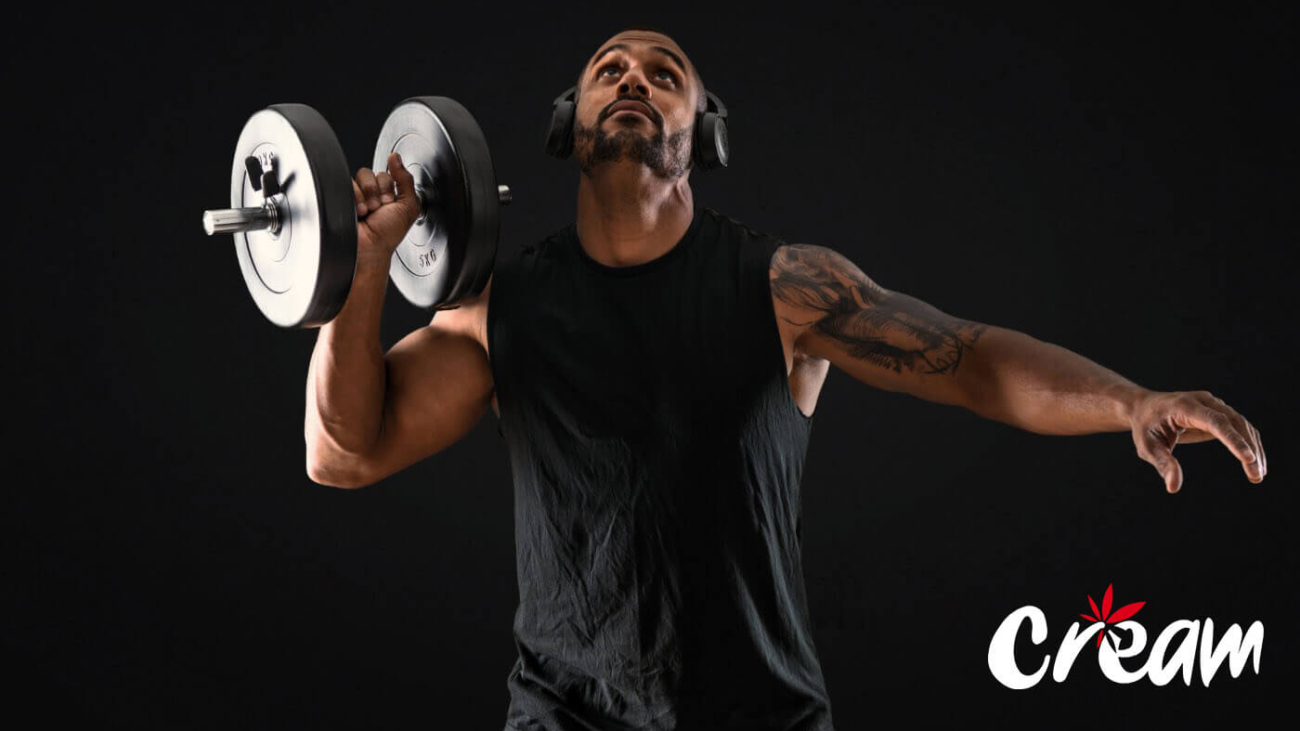 Muscular guy weightlifting at CREAM cannabis dispensary in Jersey City.